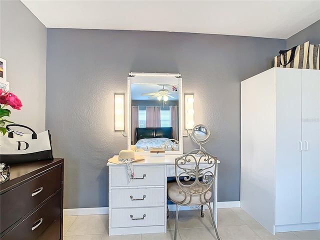 bathroom featuring ceiling fan and tile patterned flooring