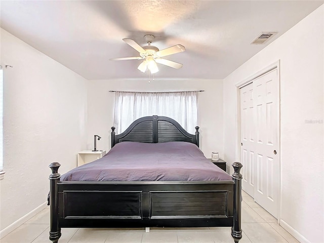 bedroom with light tile patterned floors and ceiling fan