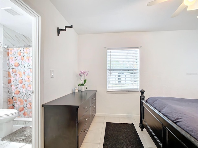 tiled bedroom featuring ceiling fan and ensuite bathroom