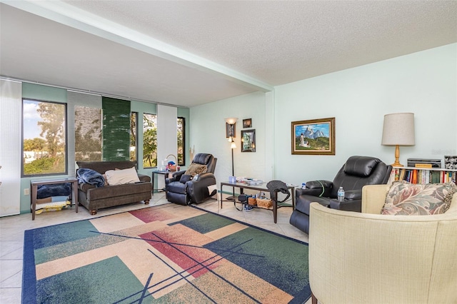 tiled living room featuring a textured ceiling