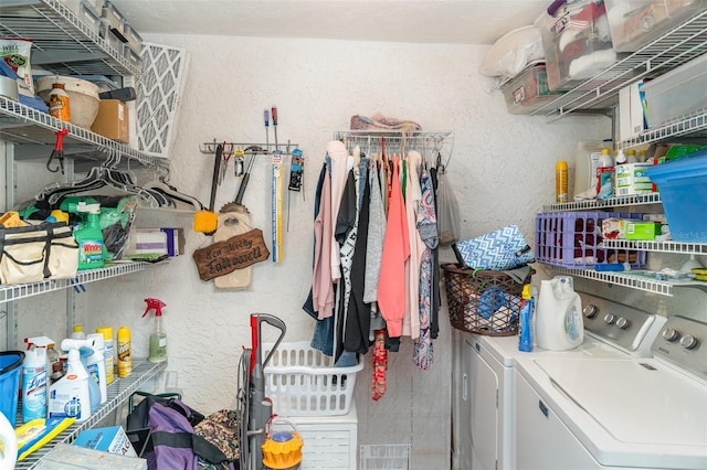 127 Tidewater Dr Unit 127, Bradenton, FL 34210 - washroom with laundry area, visible vents, a textured wall, and washer and clothes dryer