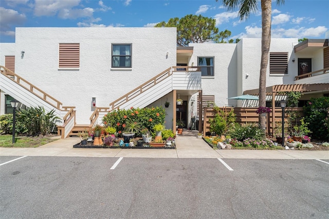 127 Tidewater Dr Unit 127, Bradenton, FL 34210 - view of property featuring stairs and fence