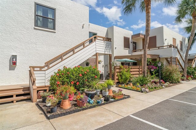 127 Tidewater Dr Unit 127, Bradenton, FL 34210 - exterior space with uncovered parking, stucco siding, and stairs