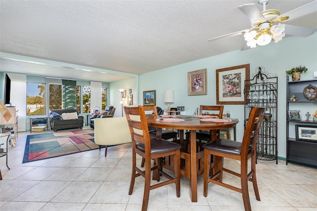 127 Tidewater Dr Unit 127, Bradenton, FL 34210 - dining room featuring ceiling fan, a textured ceiling, and light tile patterned floors