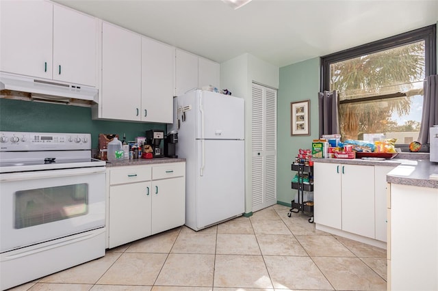 127 Tidewater Dr Unit 127, Bradenton, FL 34210 - kitchen featuring white cabinetry, white appliances, light tile patterned floors, and under cabinet range hood
