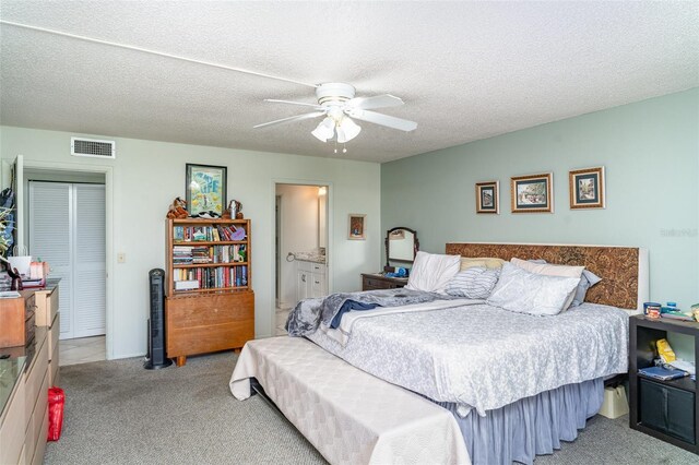 127 Tidewater Dr Unit 127, Bradenton, FL 34210 - carpeted bedroom with connected bathroom, a ceiling fan, and visible vents