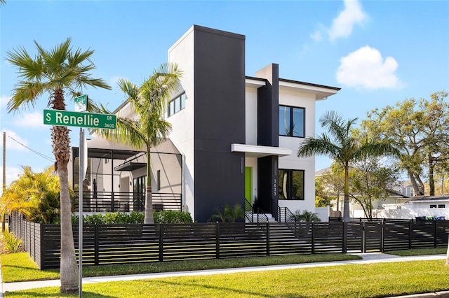 exterior space with stucco siding and a fenced front yard