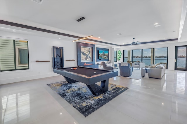 game room with a raised ceiling, a water view, billiards, and ceiling fan