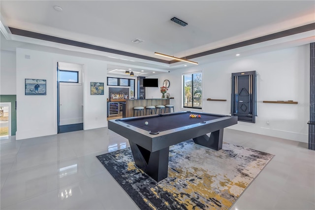 recreation room featuring bar, a tray ceiling, billiards, and tile patterned flooring