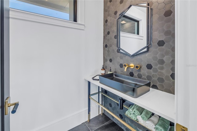 bathroom with sink, tile patterned flooring, and decorative backsplash