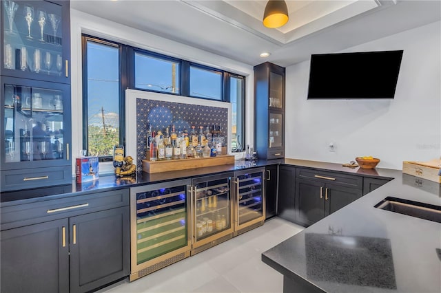 bar featuring sink and beverage cooler