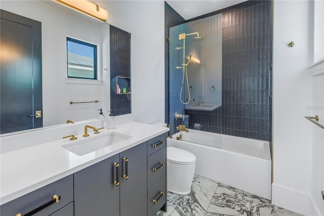 full bathroom featuring vanity, tiled shower / bath, and toilet