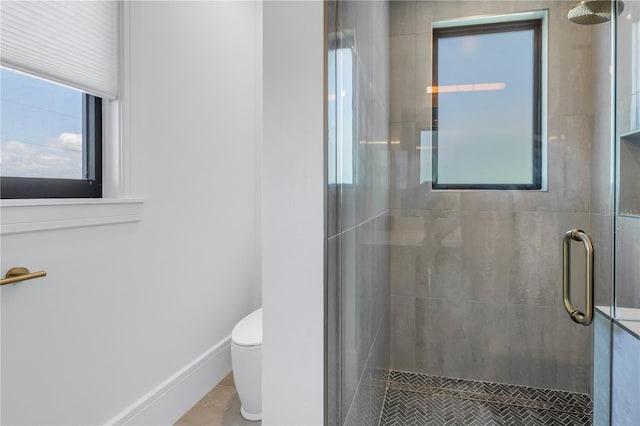 bathroom with tile patterned floors, toilet, and walk in shower