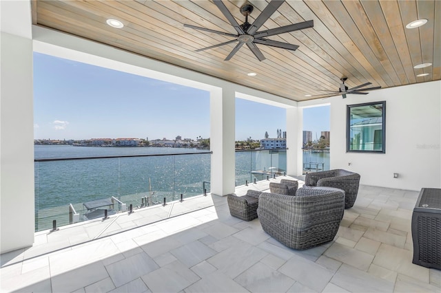 view of patio / terrace with a water view and ceiling fan