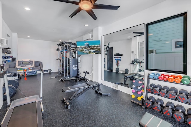 exercise room with ceiling fan and a wall mounted air conditioner