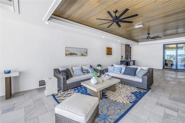 living room featuring a tray ceiling, wooden ceiling, and ceiling fan