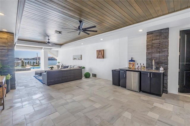 view of patio with ceiling fan, an outdoor wet bar, and an outdoor hangout area