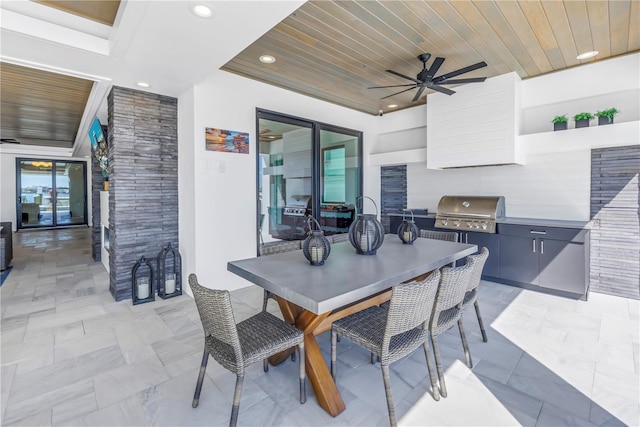 view of patio with ceiling fan, area for grilling, and grilling area