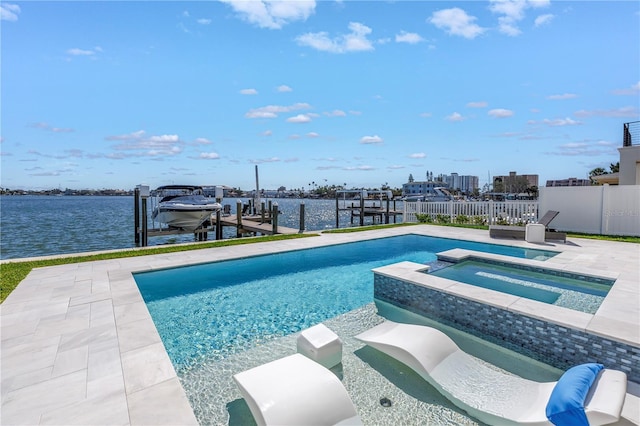 view of swimming pool featuring a dock, a water view, a patio area, and an in ground hot tub