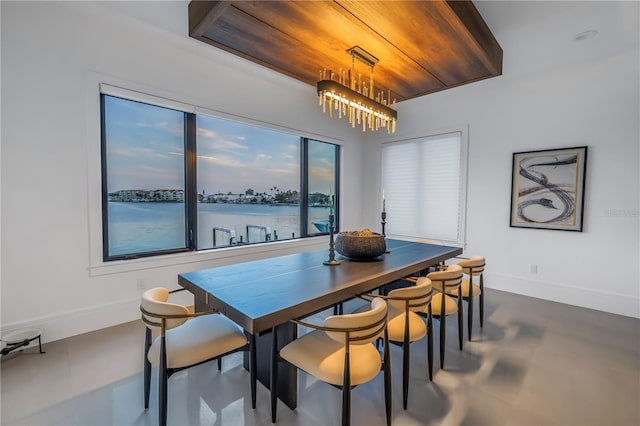 dining space with a water view and concrete floors