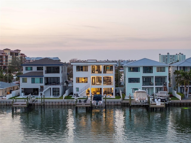 back house at dusk with a water view