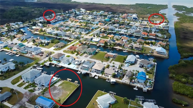 birds eye view of property featuring a water view and a residential view