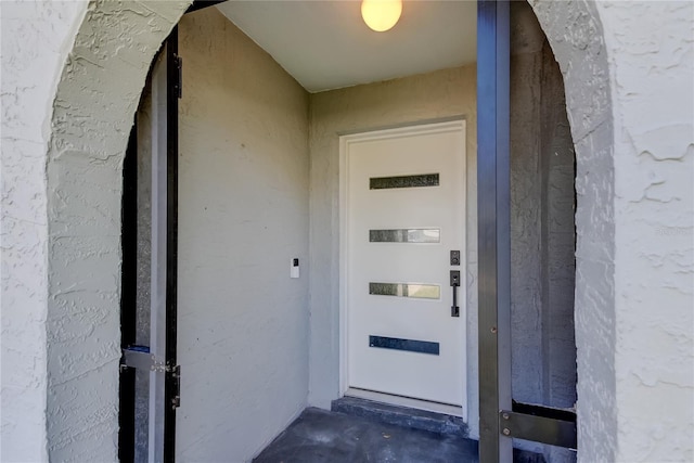 doorway to property with stucco siding