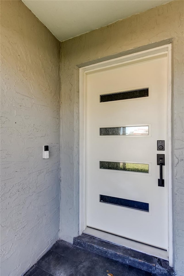 property entrance featuring stucco siding