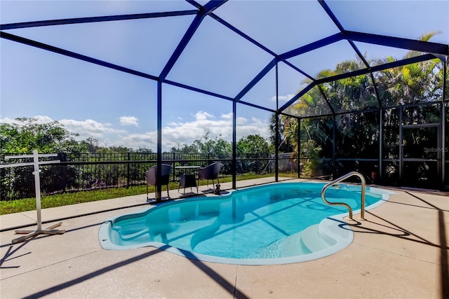 view of pool featuring glass enclosure, a patio area, fence, and a fenced in pool