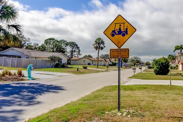 view of road with traffic signs and a residential view