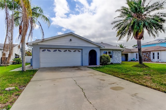 single story home with concrete driveway, a front lawn, and an attached garage