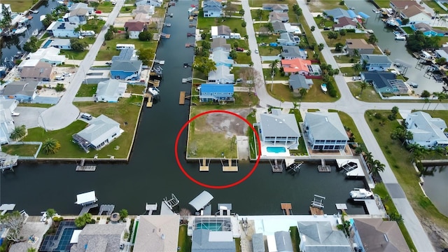 bird's eye view featuring a water view and a residential view