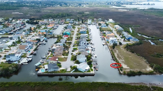 drone / aerial view featuring a water view and a residential view