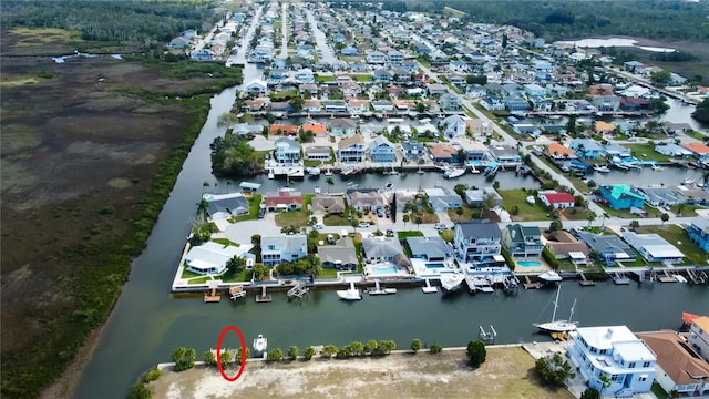 birds eye view of property with a water view and a residential view