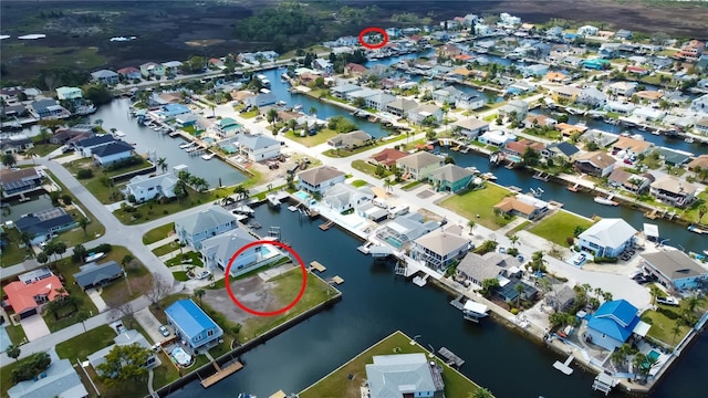 birds eye view of property with a water view and a residential view