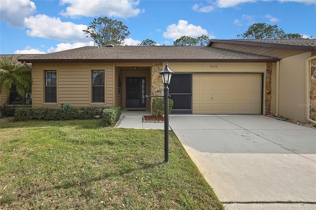 ranch-style house featuring a garage, a front yard, and driveway