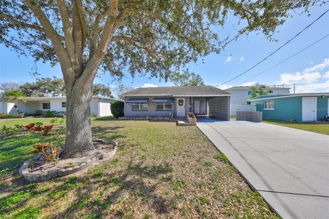 single story home featuring a front lawn, concrete driveway, and a carport