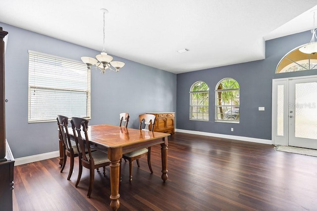 dining area with an inviting chandelier and dark hardwood / wood-style floors