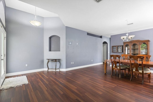 dining area with a chandelier and dark hardwood / wood-style floors