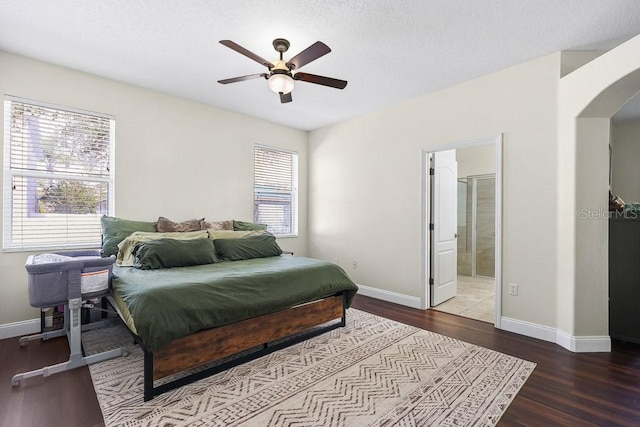 bedroom with connected bathroom, ceiling fan, and wood-type flooring