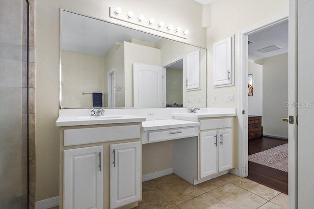 bathroom with vanity and tile patterned flooring