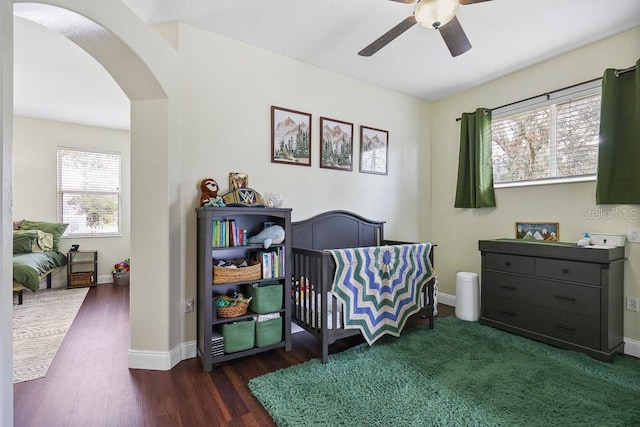 bedroom featuring ceiling fan and dark wood-type flooring