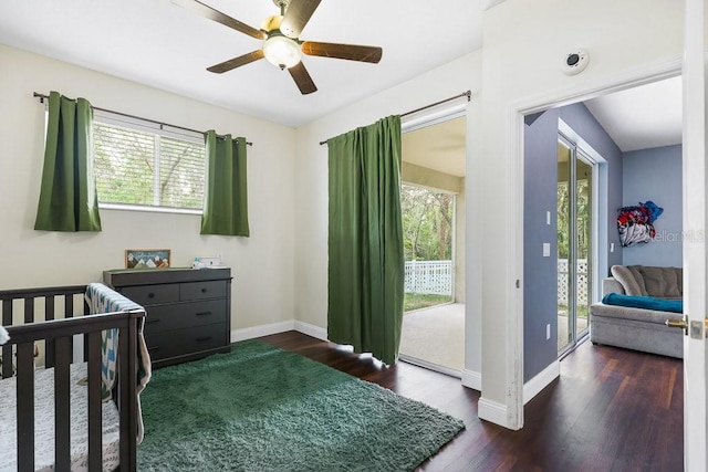 bedroom featuring ceiling fan, dark wood-type flooring, and access to outside