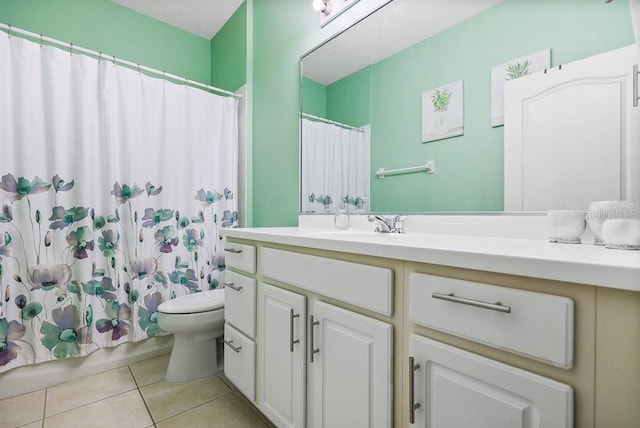 bathroom featuring tile patterned floors, vanity, a shower with shower curtain, and toilet