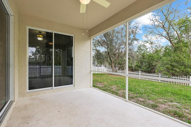 unfurnished sunroom with ceiling fan