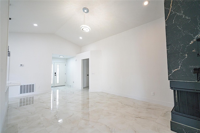 unfurnished living room featuring lofted ceiling