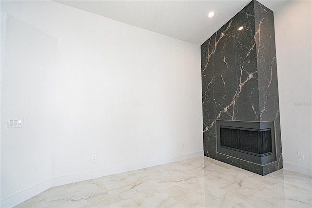 unfurnished living room with a premium fireplace