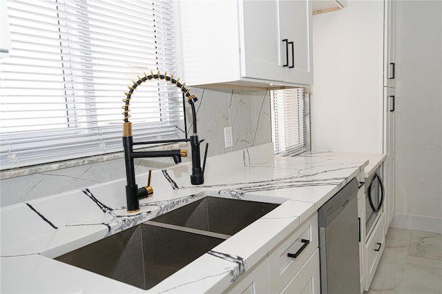 kitchen with sink, dishwasher, light stone countertops, decorative backsplash, and white cabinets