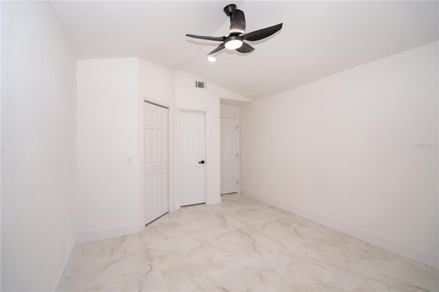 unfurnished bedroom with vaulted ceiling, a closet, and ceiling fan