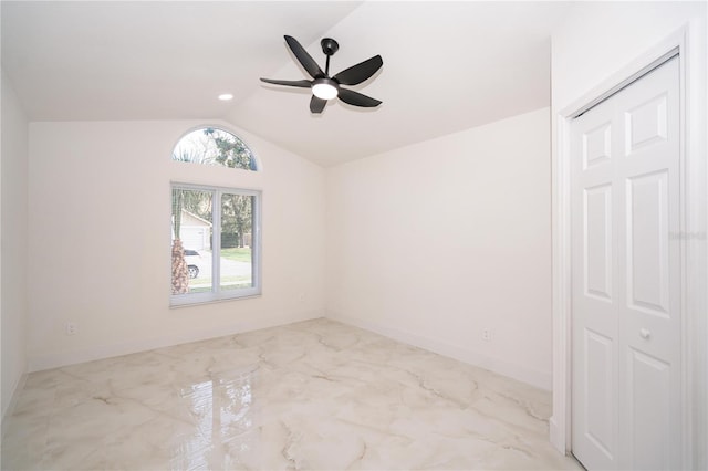 spare room featuring vaulted ceiling and ceiling fan